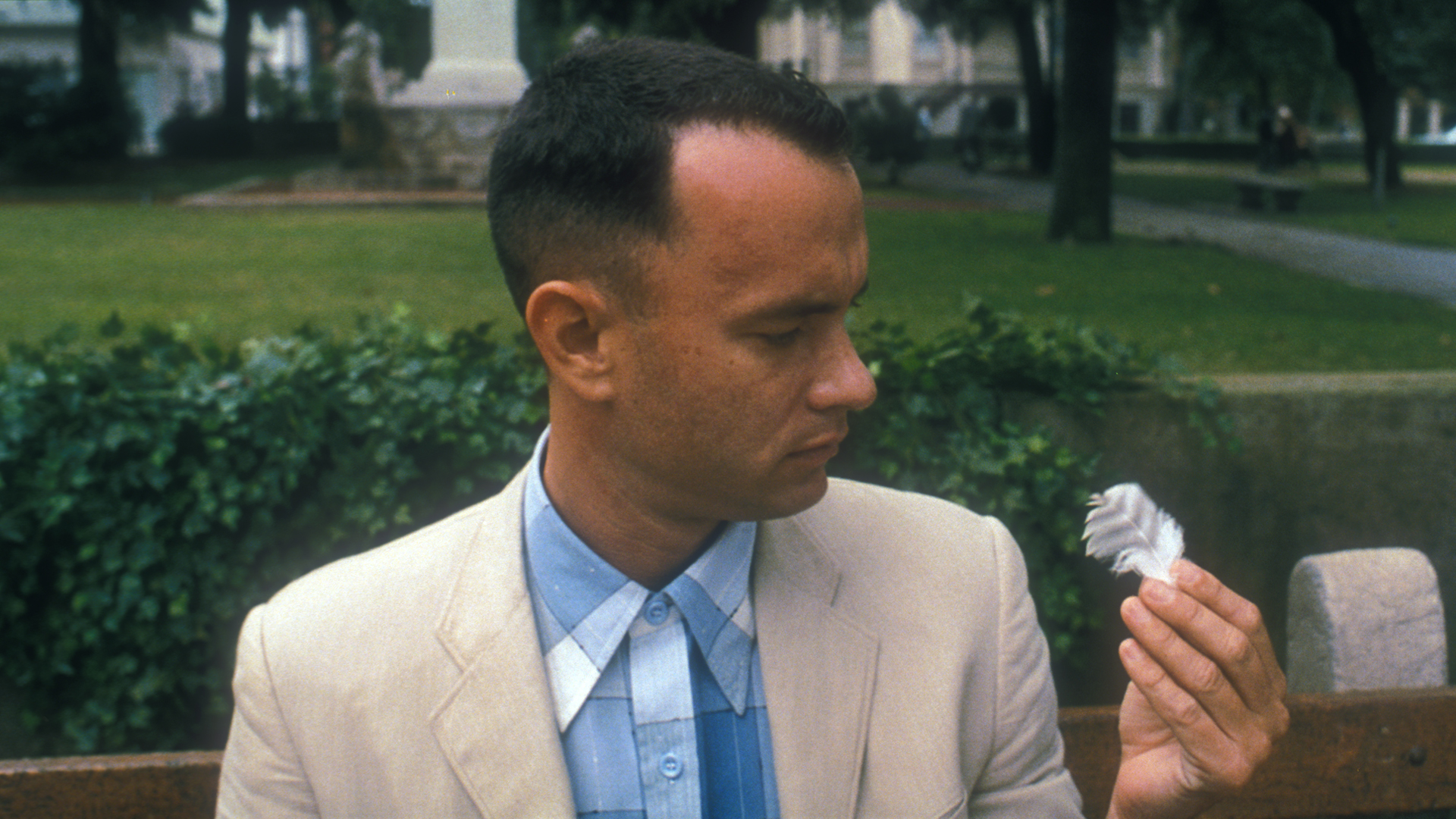 Forrest Gump (Tom Hanks) studies a feather in the Academy Award®-Winning Forrest Gump (1994). © Paramount Pictures. All Rights Reserved.
